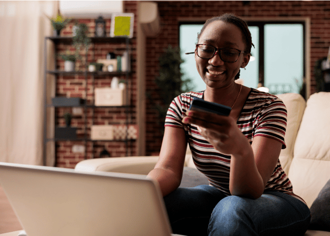 smiling African American college student shopping online