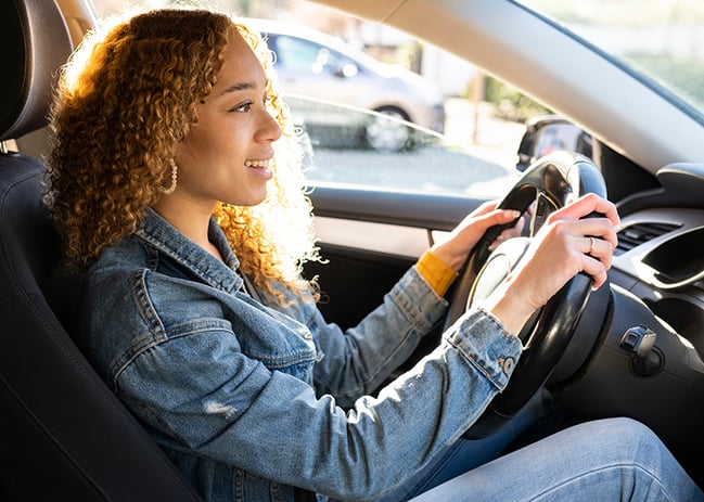 young hispanic woman driving auto