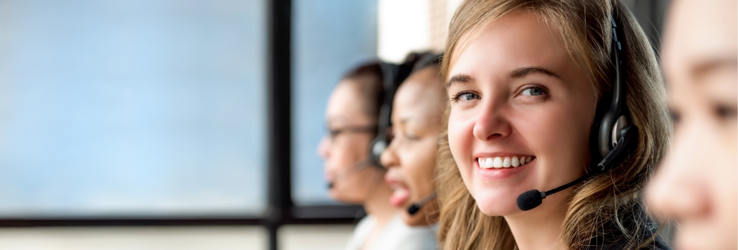 Smiling woman wearing telephone headset