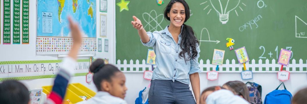 female hispanic teacher instructing students