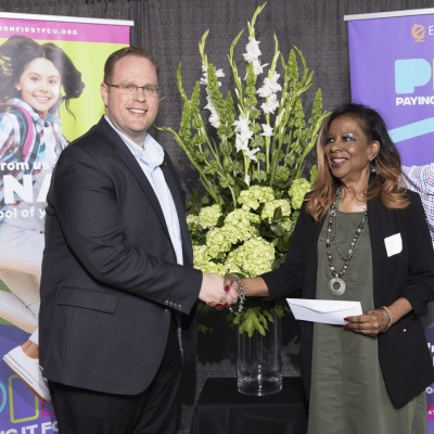 Education First CEO Kevin Conn presenting check to school administrator