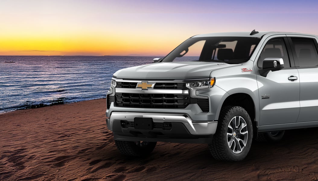 Silver Truck on a Beach with a sunset