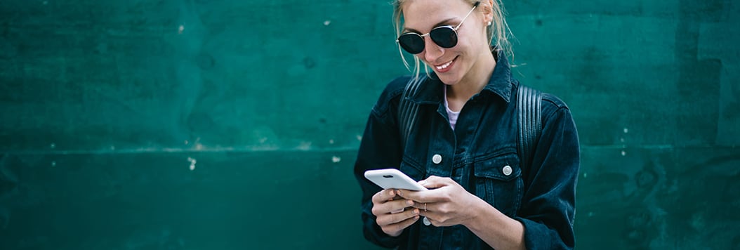 young woman using her mobile phone for banking transactions