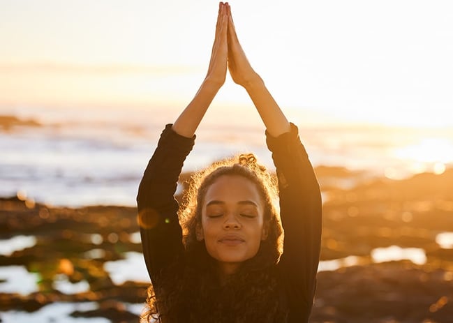 attractive woman doing yoga on the beach_800x571