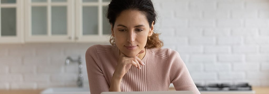 Hispanic woman reviewing finances online