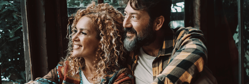 Middle Aged Hispanic Couple looking out of window