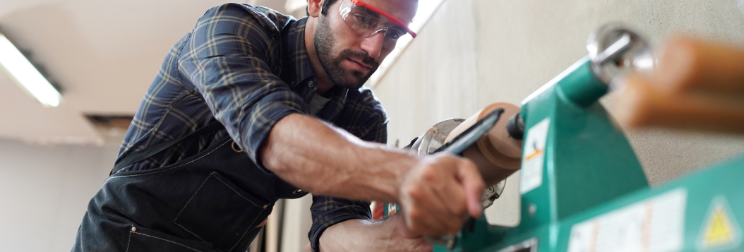 Carpenter working with equipment in shop