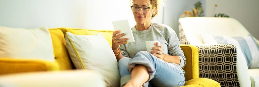 middle aged woman readying ebook on tablet