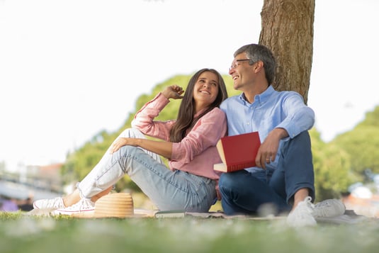 outdoor-leisure-happy-mature-spouses-reading-book-2026-03-24-03-08-57-utc