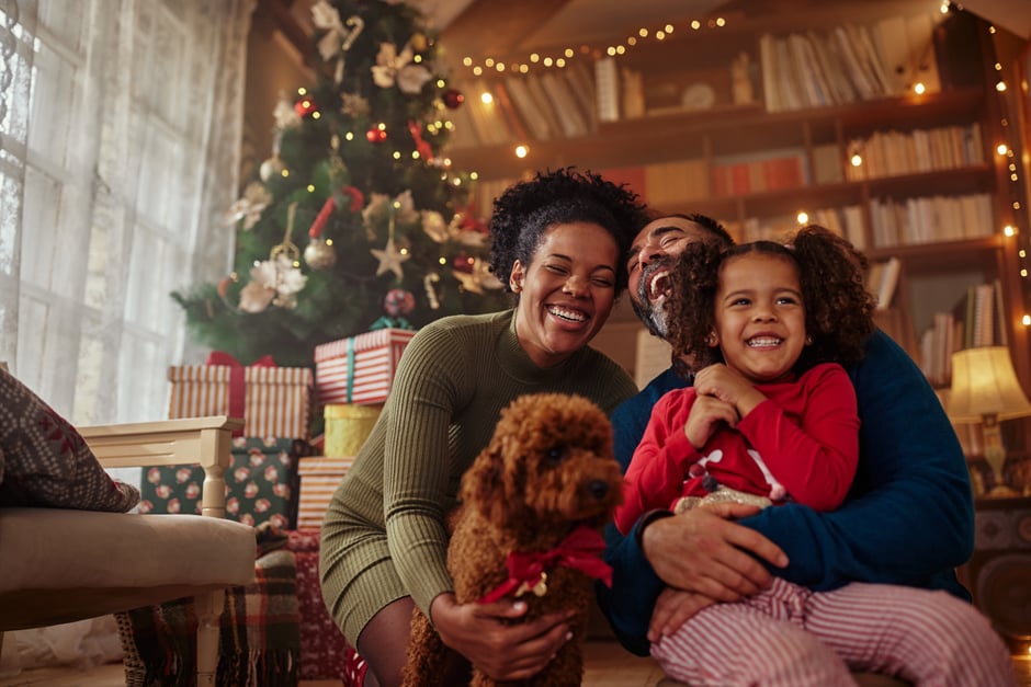 Interracial family celebrating christmas laughing and hugging