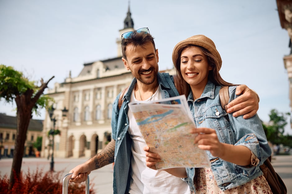 Couple walking around city with a map