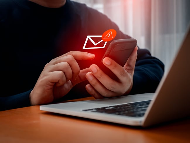 man receiving an alert regarding fraud