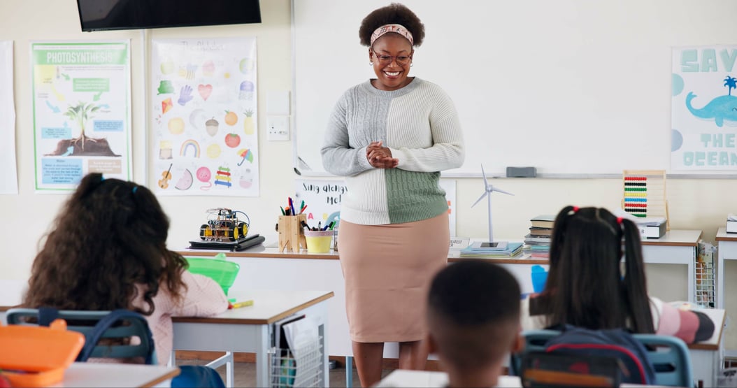 smiling-teacher-and-students-in-cheerful-classroom-2026-01-09-10-47-43-utc