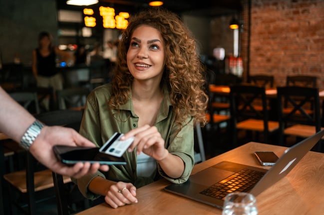 young-woman-making-a-payment-while-sitting-at-a-mo-2026-01-11-10-50-18-utc