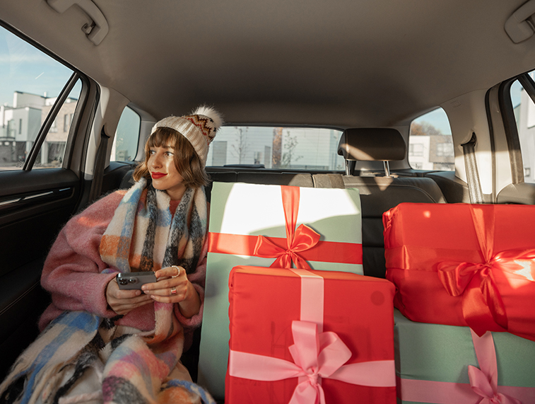 woman-in-car-with-christmas-presents