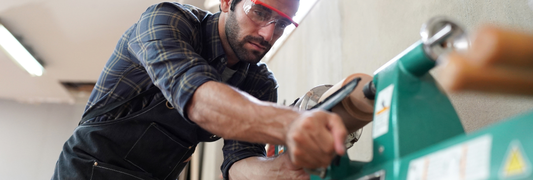 Carpenter working with equipment in showp