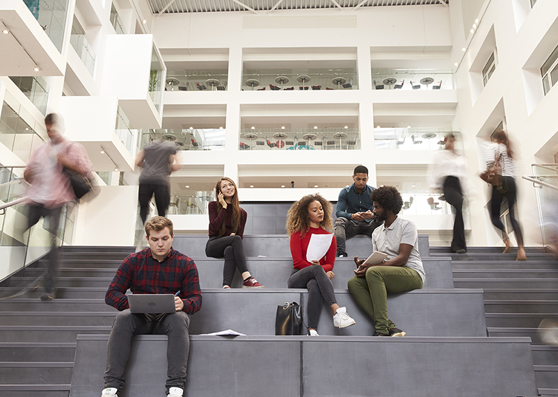 college students in busy campus building